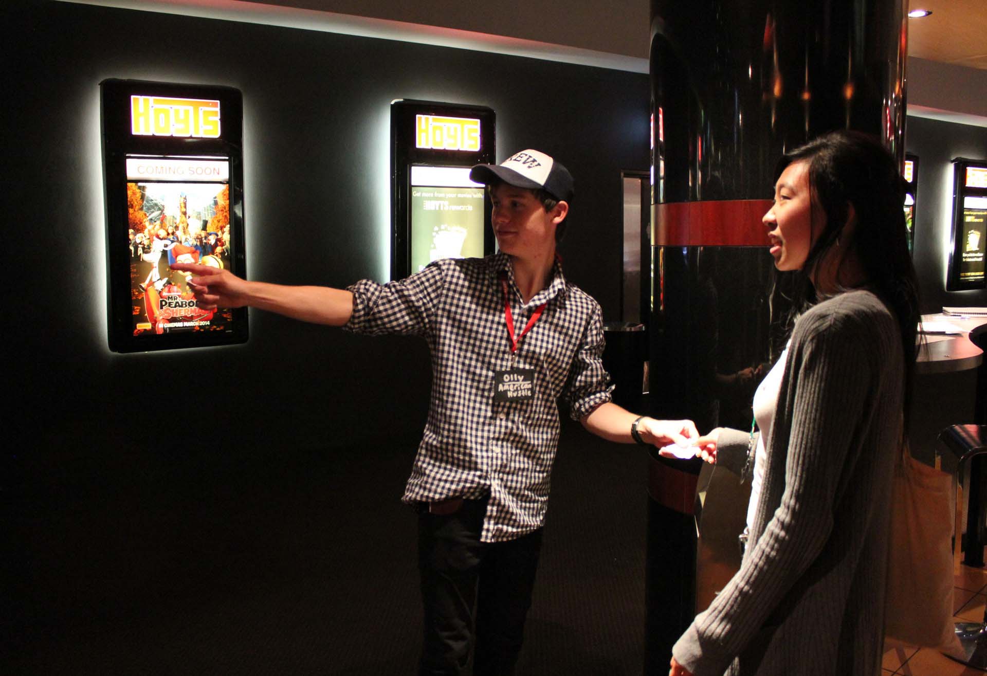 Hoyts employee directing a customer