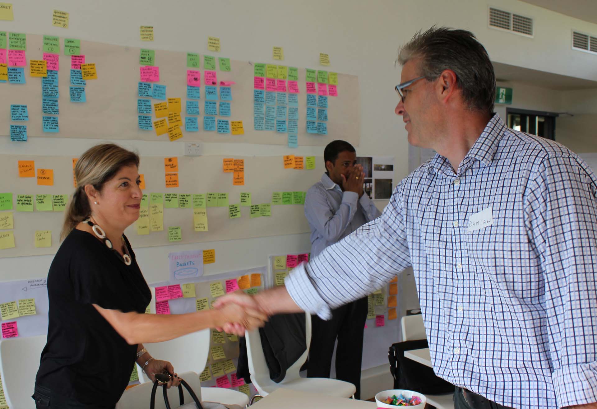 Proto CEO Damian Kernahan shaking hands with client
