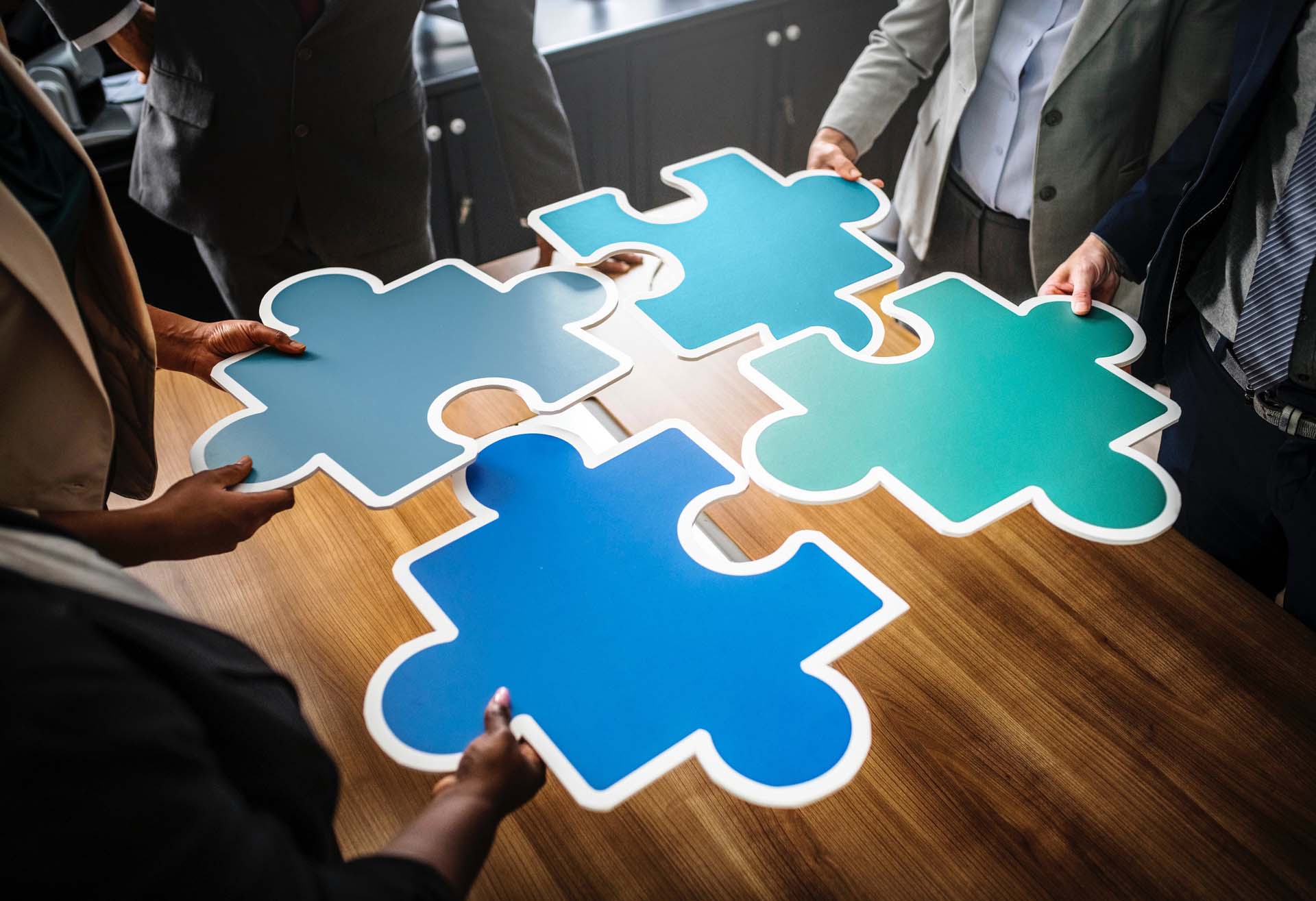 Four puzzle pieces representing the four stages of Service Design
