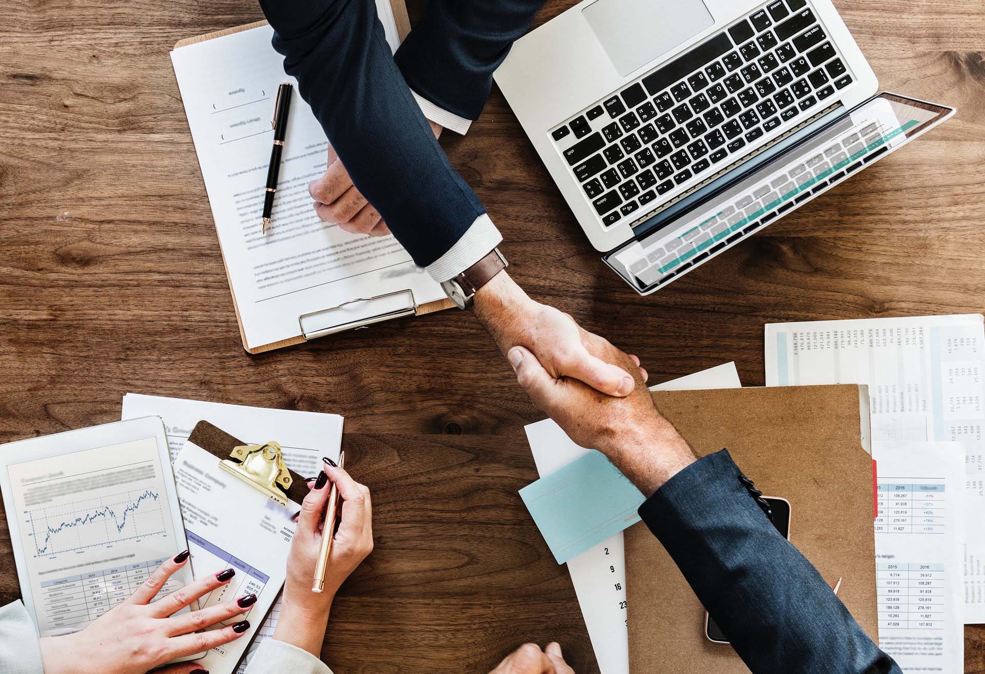 People shaking hands in a business meeting representing brilliant business basics