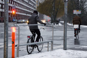 Biker rests hands on a bike railing in Copenhagen, Denmark
