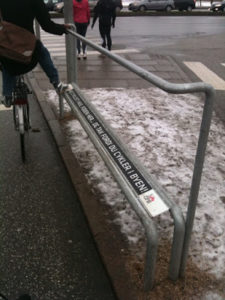 Biker rests foot on a bike railing in Copenhagen, Denmark