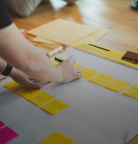 People in a workshop writing on sticky notes