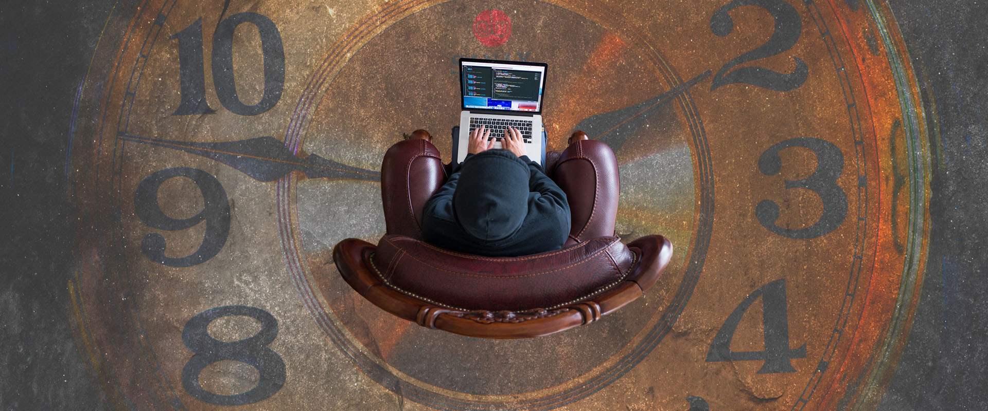 Aerial photo of customer in a chair using a laptop over a large clock representing customer lifetime value