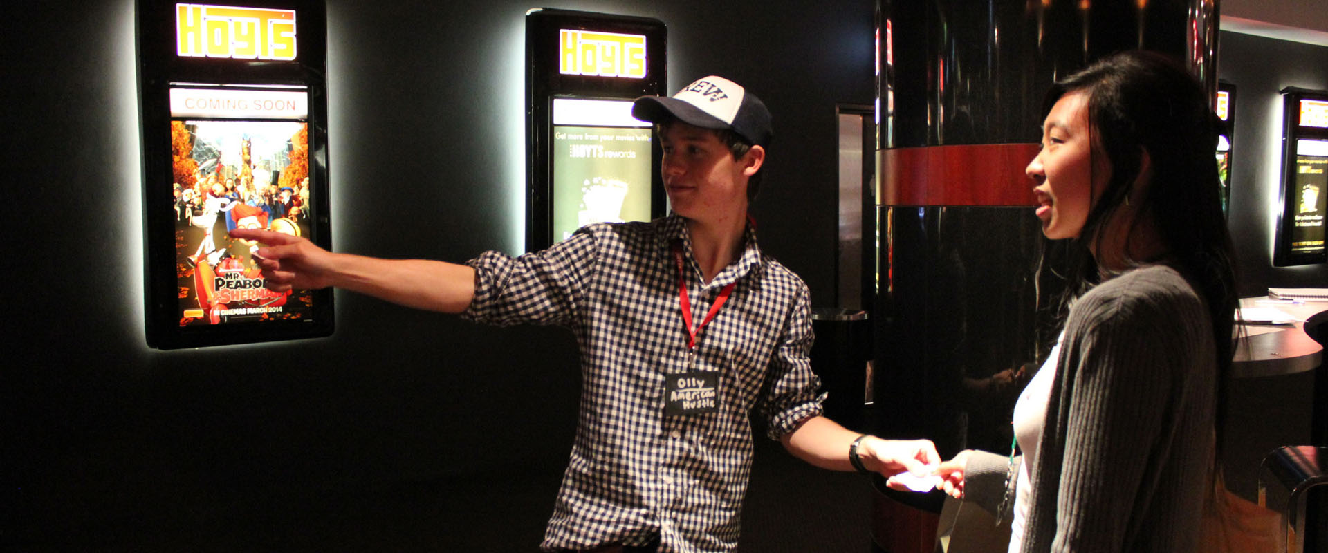 Hoyts employee directing a customer