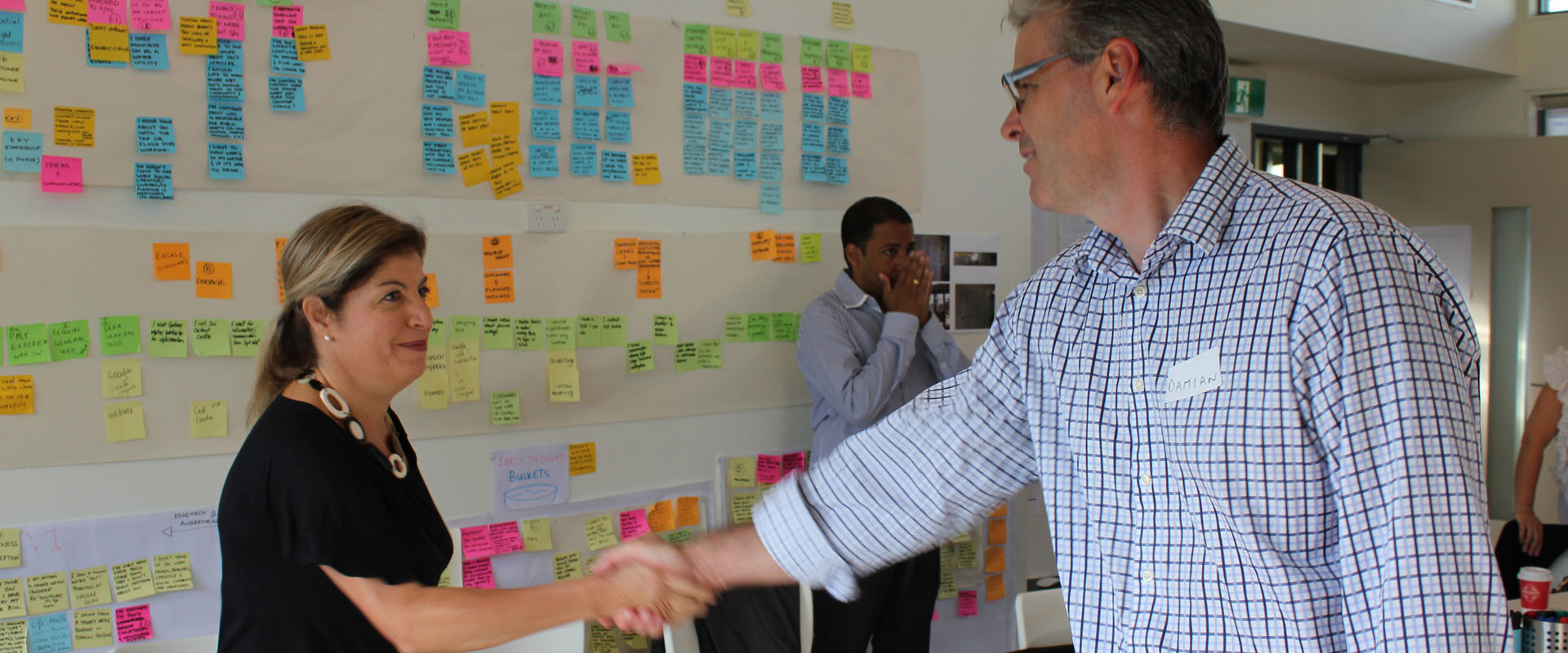 Proto CEO Damian Kernahan shaking hands with client