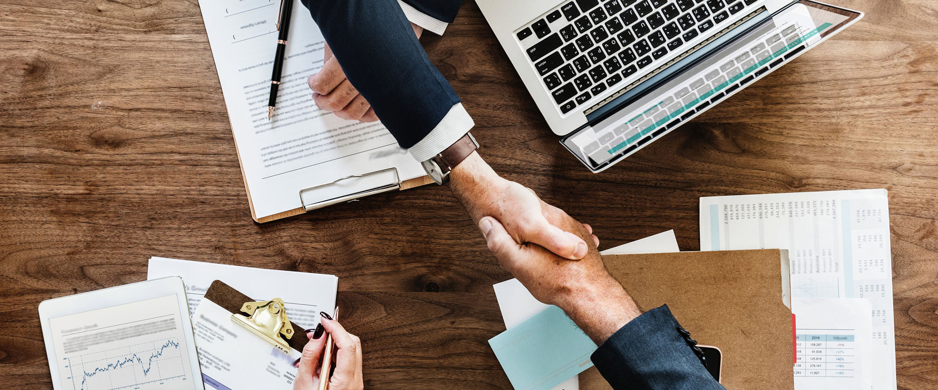 People shaking hands in a business meeting representing brilliant business basics